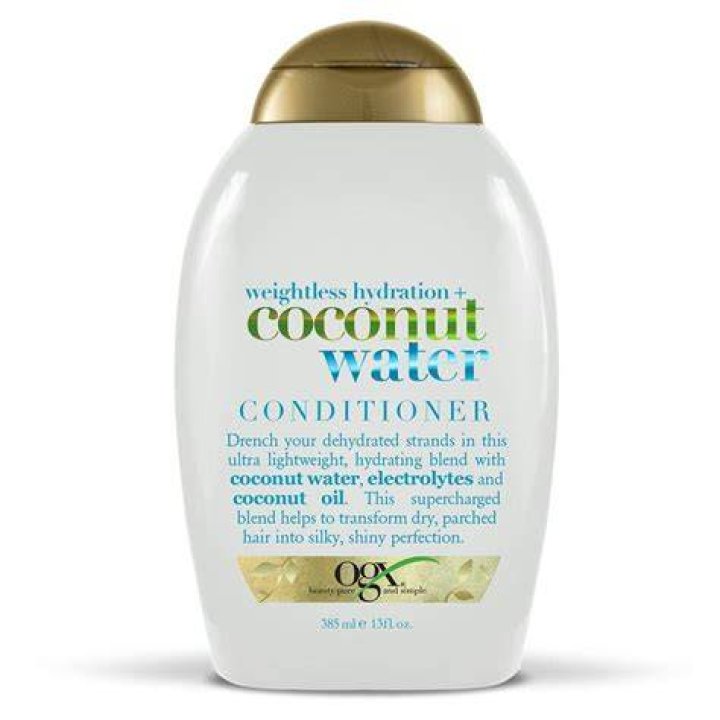 A bottle of ogx lightweight coconut fine curls conditioner for curly hair