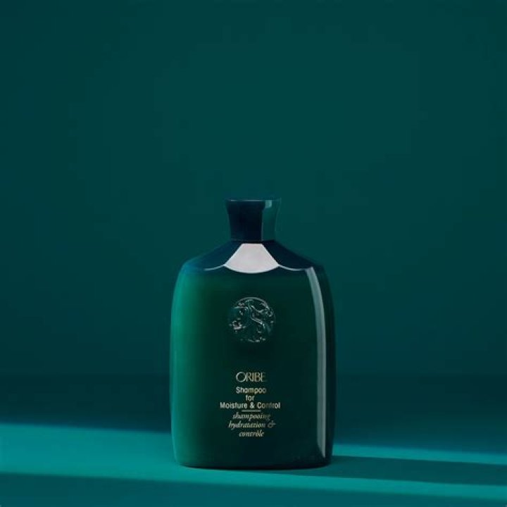A bottle of oribe intense conditioner for curly hair