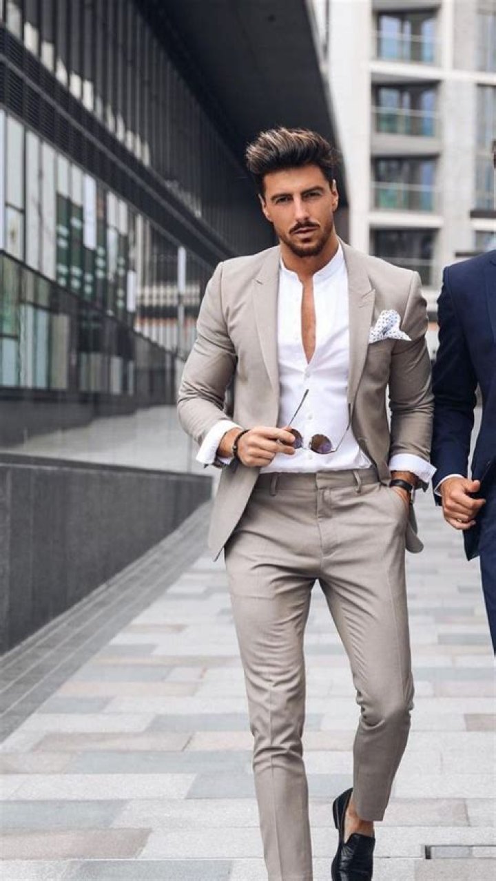 a man in a suit and tie with a quote on the side that says, think like