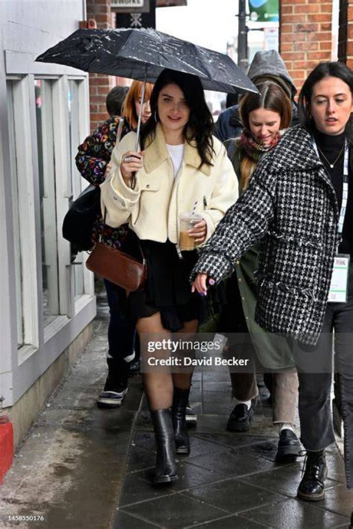 Actress Eve Hewson walks with her boyfriend, Max Minghella, in Soho in