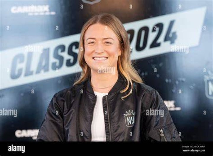 Emily Sonnett poses with trophy award
