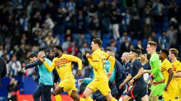 Furious Espanyol fans chase Barcelona players from the pitch after title celebrations