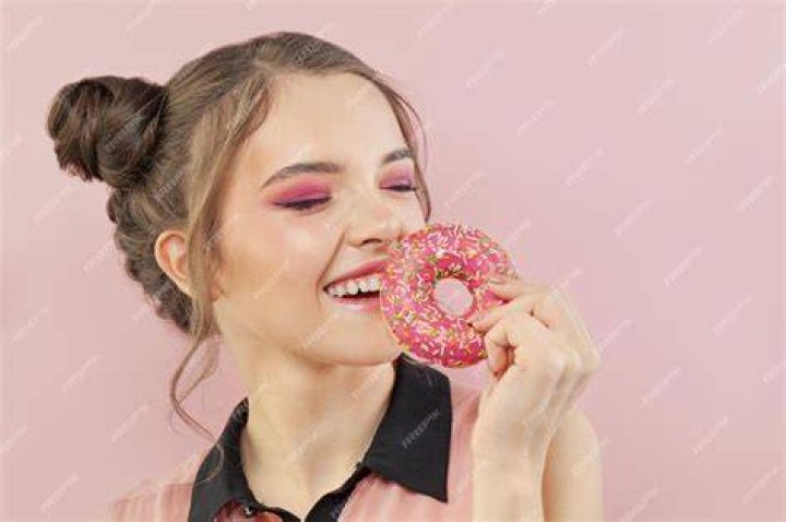 girl holding donut