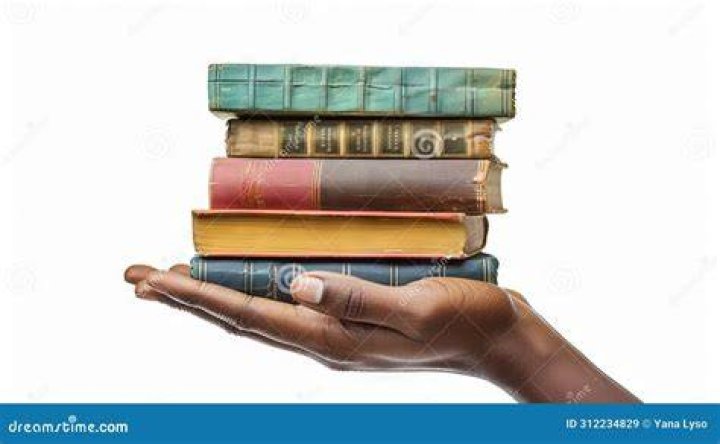 hand holding stack of books