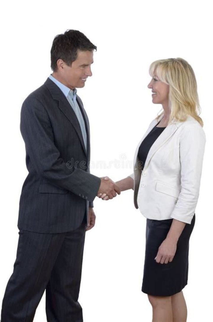 man and woman shaking hands over coffee