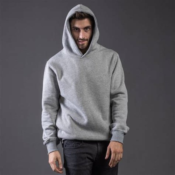 person in gray hoodie using laptop