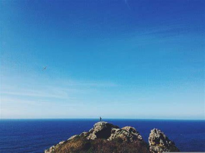 person overlooking ocean in spain