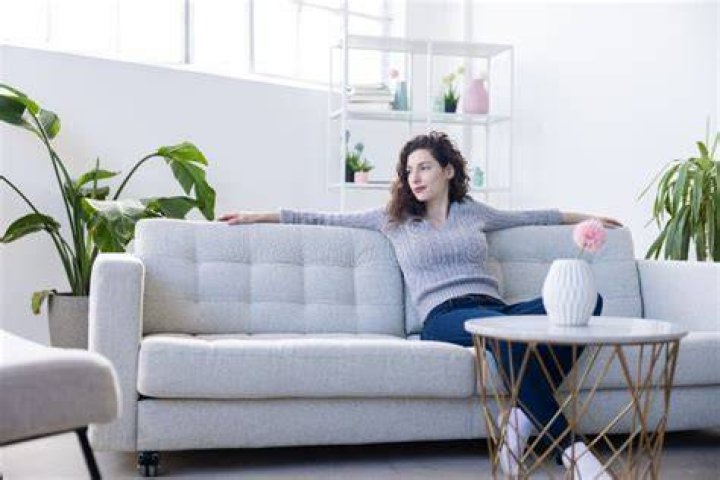 person reclined on couch with laptop