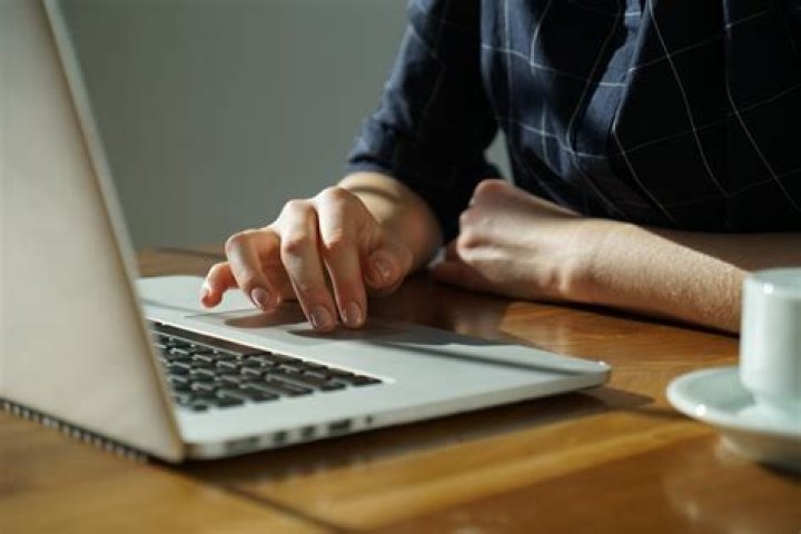 person using a laptop in a cafe