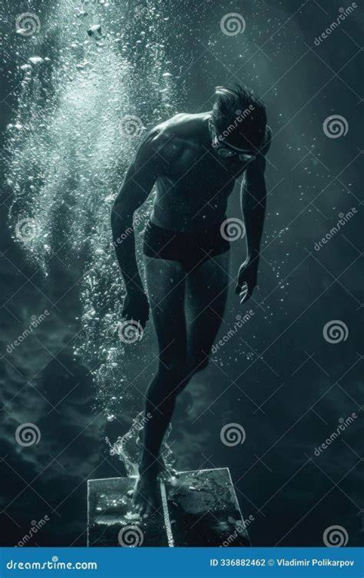 person wearing a bathing suit wades into the ocean in el nido