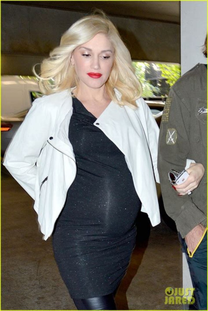 Pregnant Gwen Stefani displays her bulging bump at family Super Bowl