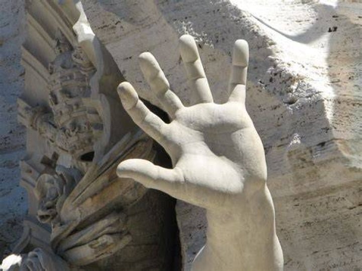 Statue of hands reaching out for help.