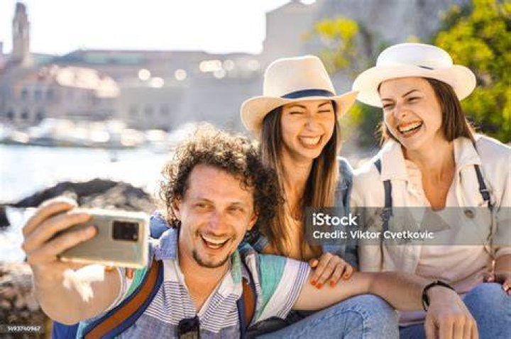 Tourists taking selfies with a selfie stick